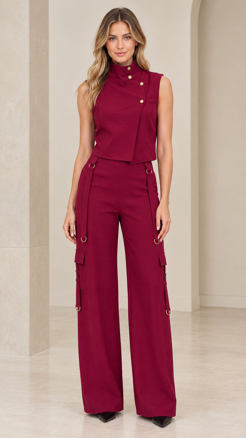 Full front view of model wearing burgundy sleeveless asymmetric vest and matching wide-leg cargo pants set
