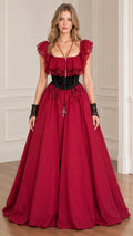 Front view of woman wearing burgundy Victorian gothic ball gown with ruffle lace trim
