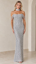 Front view of model wearing a silver pearl-embellished maxi gown with draped shoulder strands and choker