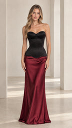 Front view of model wearing black sweetheart corset top with burgundy satin maxi skirt
