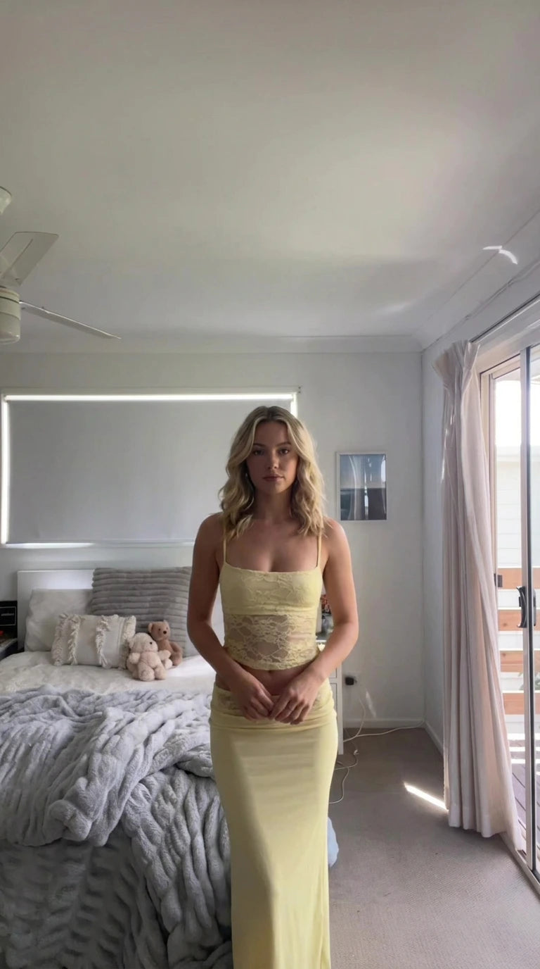 Front view of model wearing butter yellow lace cami crop top and maxi skirt set