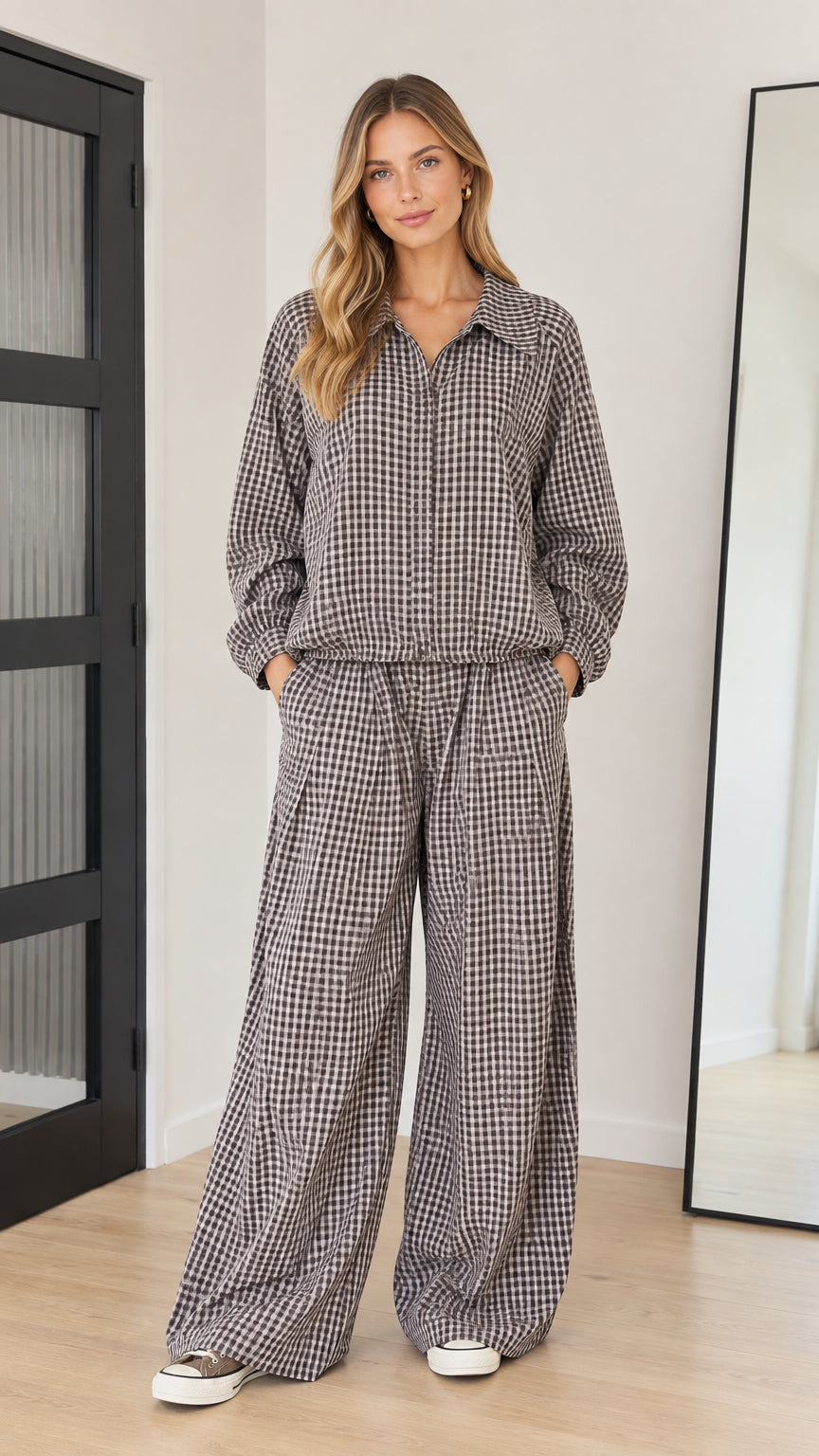 Front full-length view of model wearing brown gingham collared long-sleeve top and wide-leg pants set