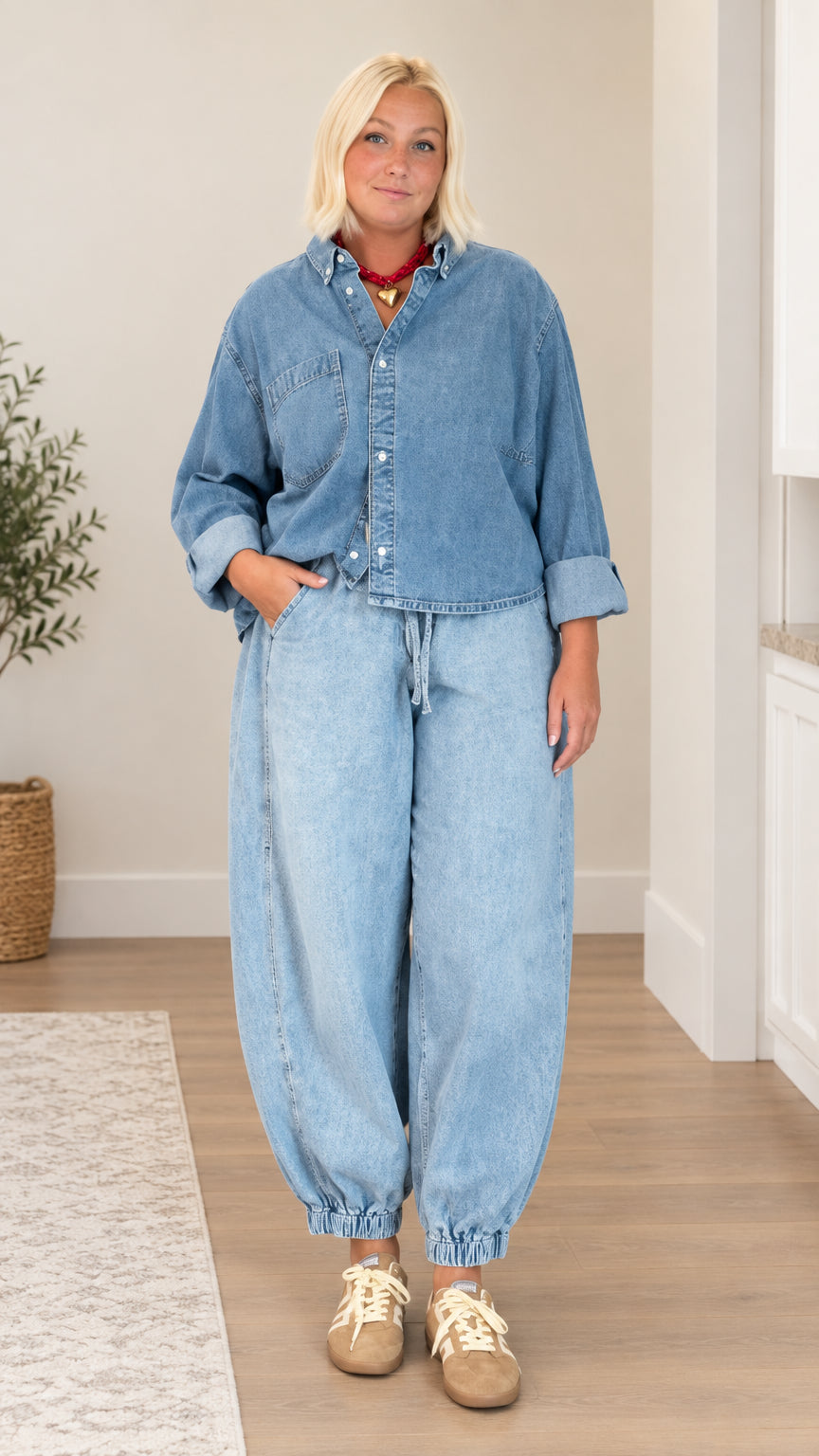 Front view of model wearing light blue denim shirt and balloon jogger pants set