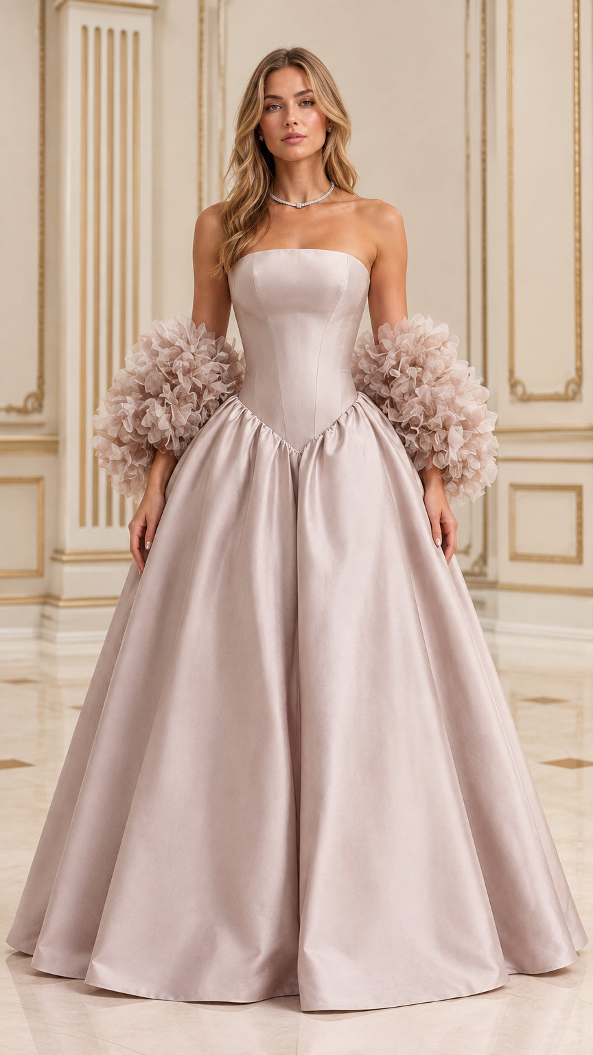 Front full-length view of model wearing dusty pink strapless basque waist ball gown with textured ruffle cuffs