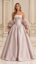 Front full-length view of model wearing dusty pink strapless basque waist ball gown with textured ruffle cuffs