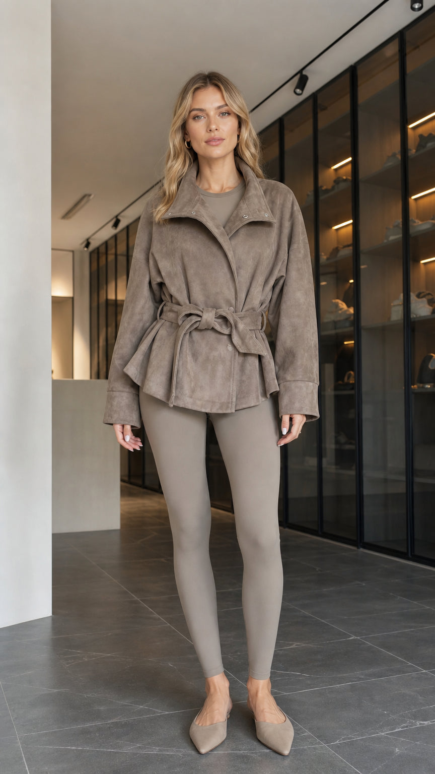 Front view of model wearing taupe faux suede belted wrap jacket with matching leggings