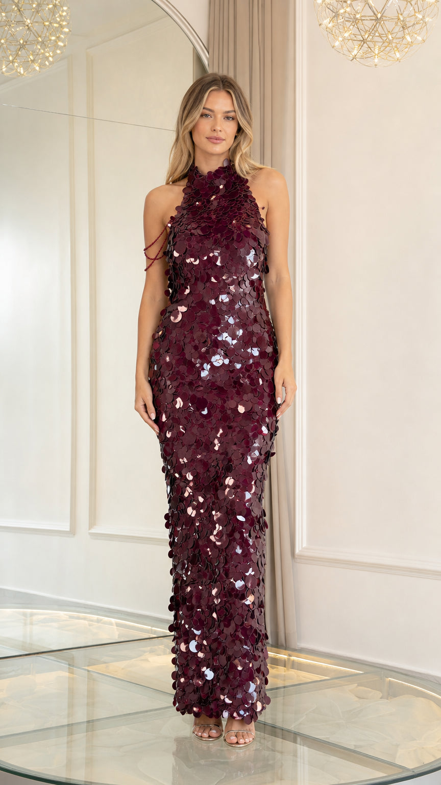 Front view of model wearing burgundy sequin halter maxi dress with beaded shoulder drape