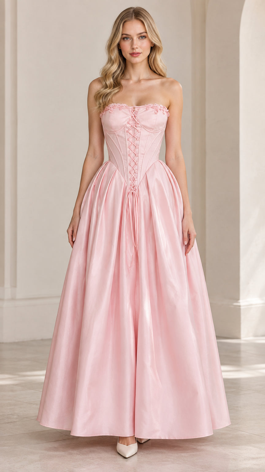 Front view of model wearing pink strapless corset ball gown maxi dress