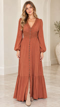 Front full-length view of woman wearing rust orange boho tiered maxi dress with lace trim and boots