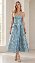 Front view of model wearing dusty blue floral jacquard sleeveless midi dress