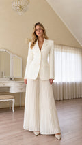 Front view of woman wearing ivory tailored blazer with matching pleated wide-leg trousers