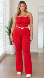 Front view of woman wearing red contrast trim cami crop top and crossover flare pants set