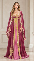 Front view of woman wearing dusty rose Renaissance velvet maxi gown with gold trim and cape sleeves