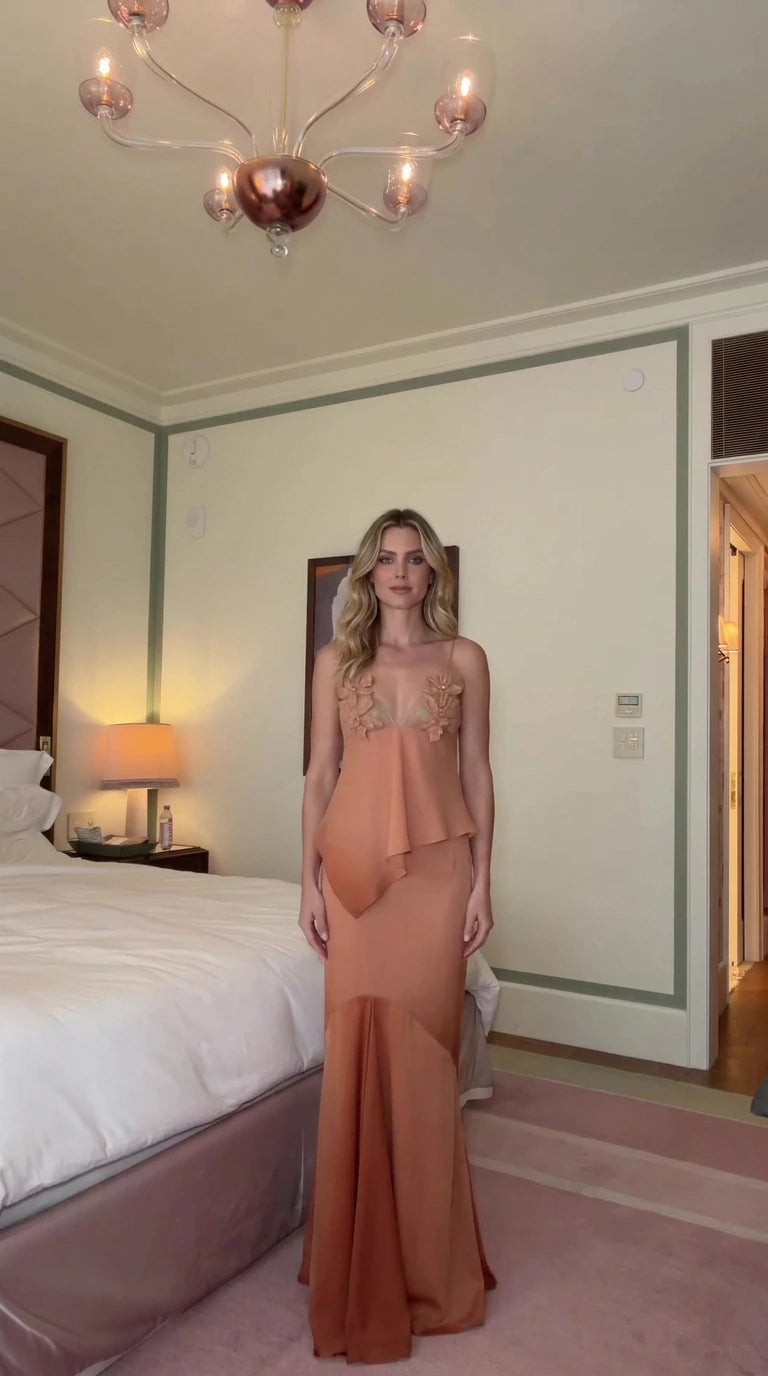 Front view of woman wearing dusty peach floral applique peplum maxi evening dress