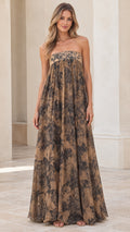 Front view of model wearing tan floral print strapless empire waist maxi dress