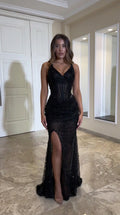 Front full view of black sequin corset mermaid gown with sweetheart neckline and thigh slit