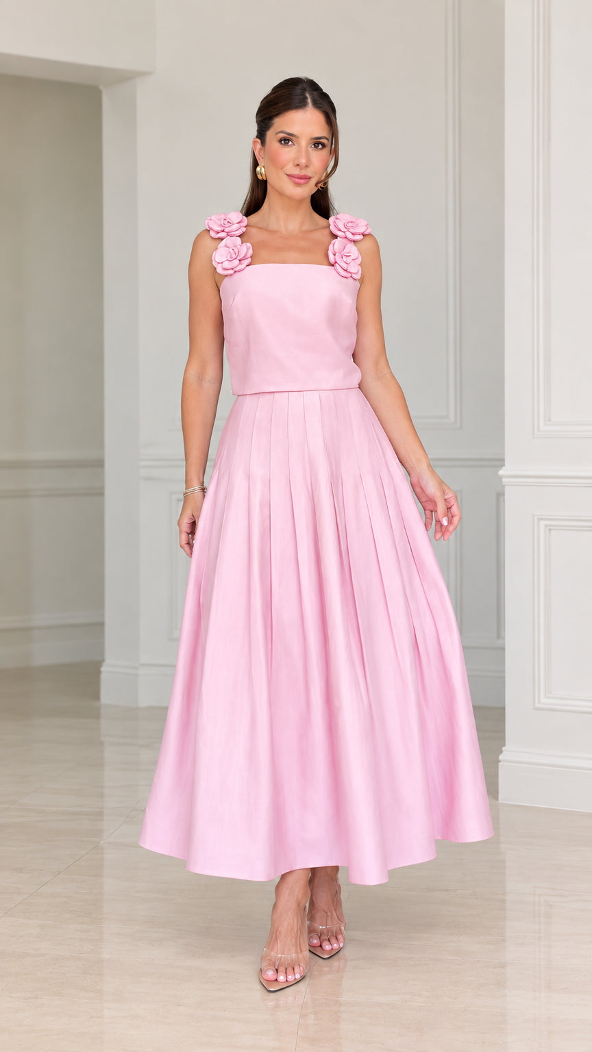 Front view of woman wearing pink floral strap pleated A-line midi dress