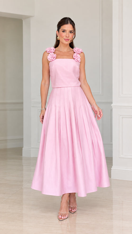 Front view of woman wearing pink floral strap pleated A-line midi dress