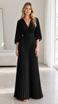 Front view of model wearing a black pleated V-neck maxi evening dress with flared sleeves