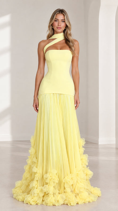 Front full-length view of model wearing yellow asymmetric drop waist pleated ruffle maxi gown