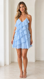 Front view of model wearing light blue tiered ruffle mini dress with spaghetti straps