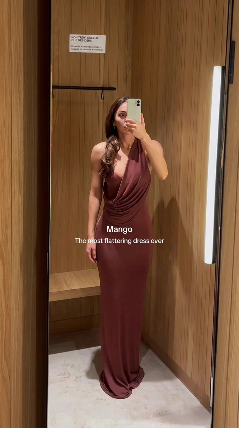 Front view of rust brown cowl neck halter maxi dress on model in dressing room