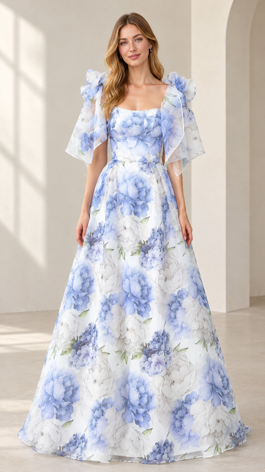 Front view of model wearing white floral print flutter sleeve maxi evening gown