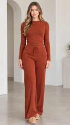 Full front view of model wearing rust long sleeve top and wide leg pants loungewear set