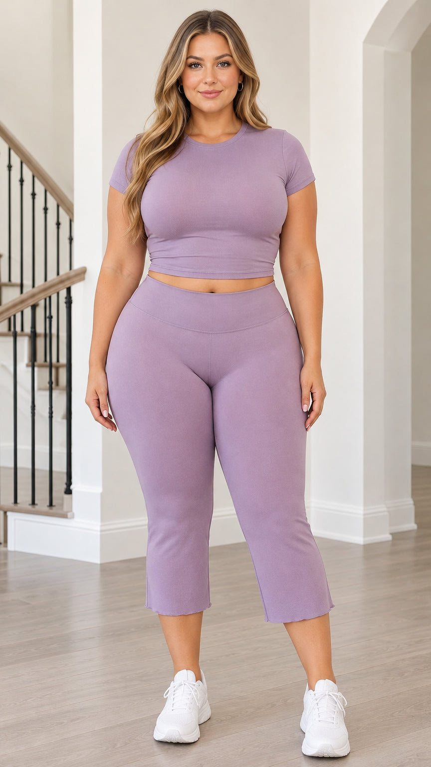Front view of woman wearing lavender ribbed crop top and matching V-waist capri leggings
