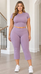 Front view of woman wearing lavender ribbed crop top and matching V-waist capri leggings