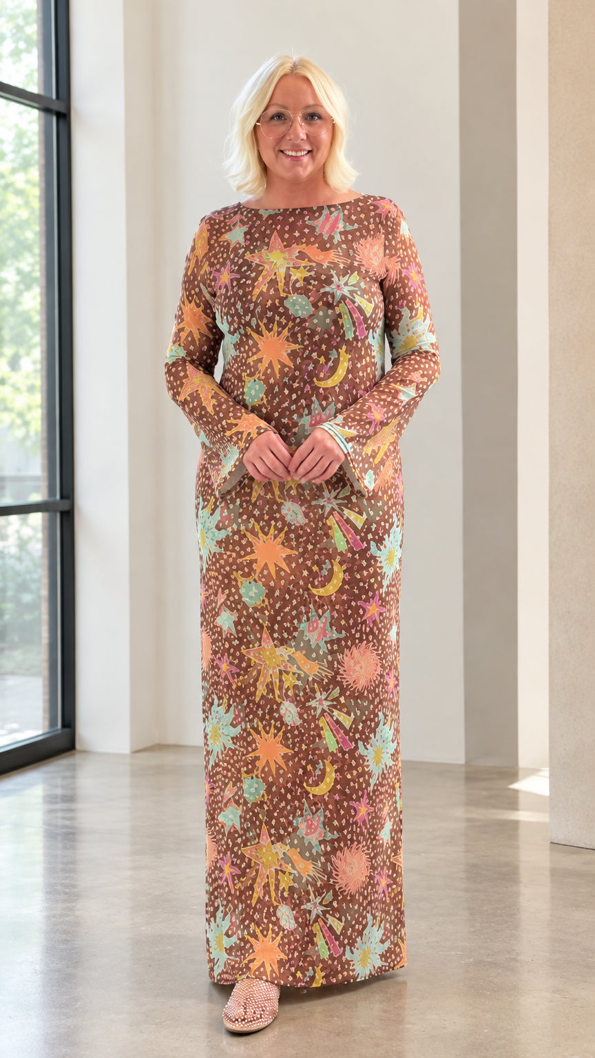 Front full view of blonde model wearing brown celestial print boat neck long sleeve maxi dress