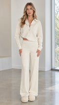 Front full view of woman wearing cream textured knit two-piece lounge set with button-down shirt and wide-leg pants