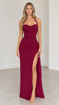 Full front view of model wearing burgundy halter sweetheart maxi dress with high leg slit