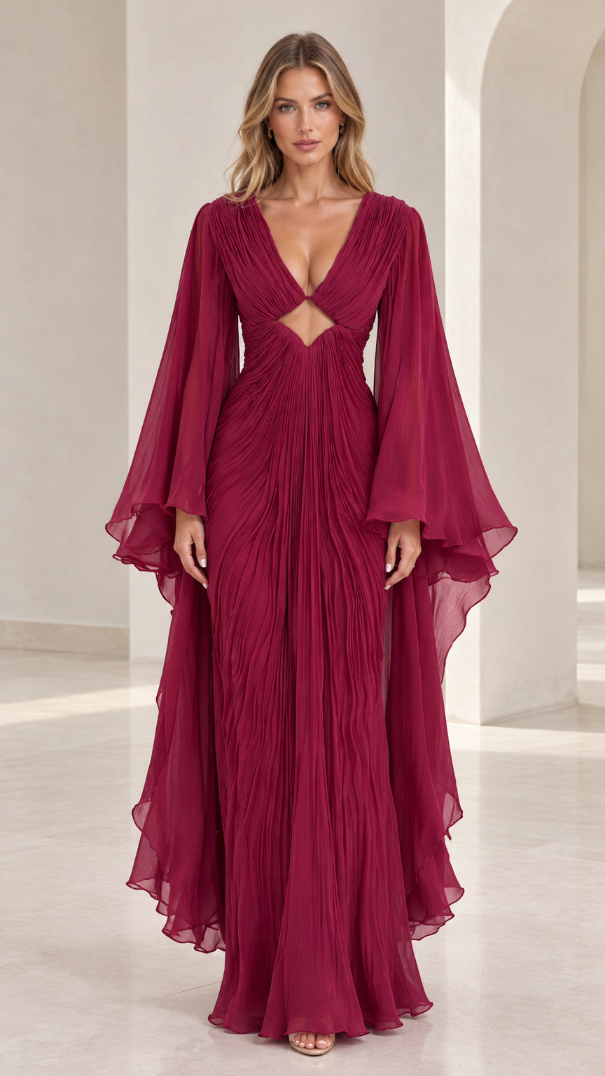 Front view of model wearing burgundy pleated V-neck evening gown with cutout detail and flared bell sleeves