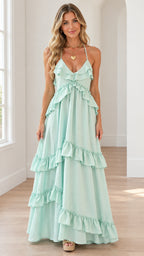Front full-length view of model wearing mint green tiered ruffle halter maxi dress