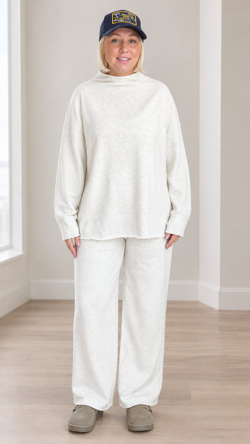 Front view of model wearing oatmeal mock neck sweatshirt and wide leg pants lounge set