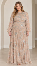 Front full view of woman wearing champagne sequined long sleeve maxi evening gown