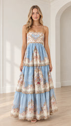 Front view of model wearing a light blue vintage floral tiered cami maxi dress