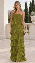 Front view of model wearing olive green strapless tiered fringe maxi dress on outdoor terrace