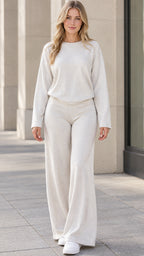 Front view of woman wearing beige long sleeve pullover and wide leg pants lounge set