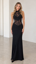 Front view of model wearing black halter neck lace inset maxi evening dress