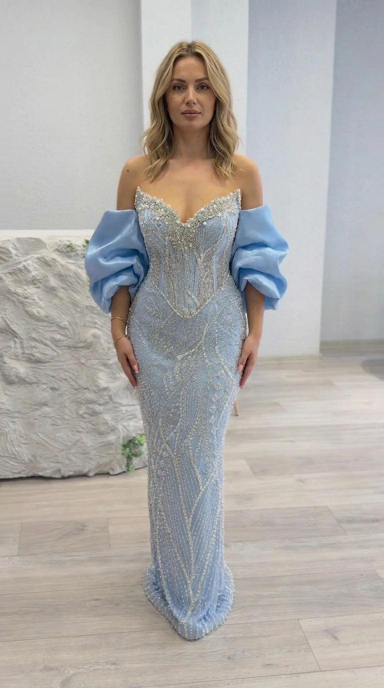 Front full-length view of light blue off-shoulder beaded corset evening gown with puff sleeves