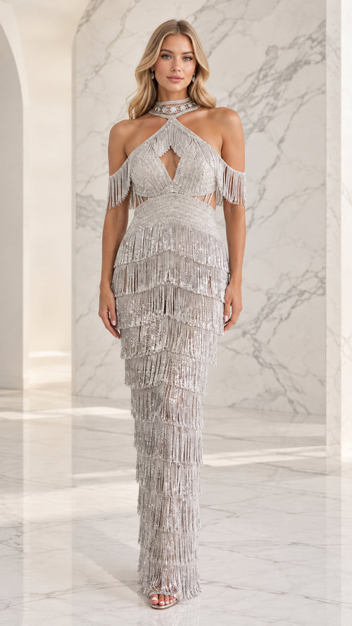 Full-length front view of woman wearing silver beaded fringe halter maxi gown with bodice cutout