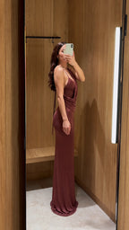 Side profile view of rust brown backless cowl neck maxi dress