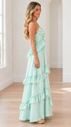 Side profile view of mint green tiered ruffle maxi dress showing layered drape