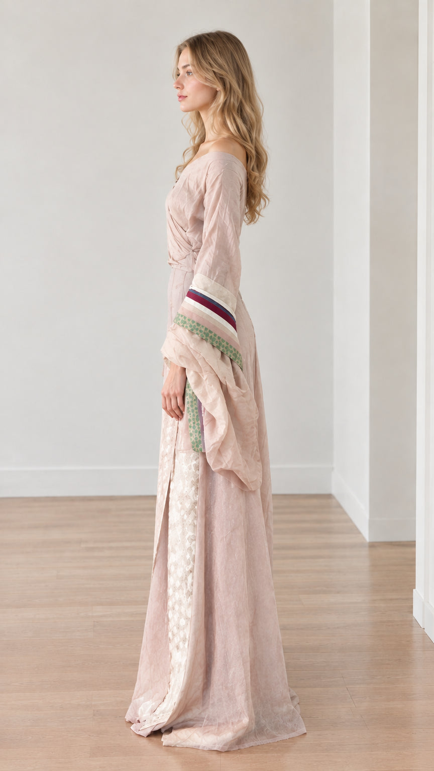 Side profile view of dusty pink medieval maxi dress showing skirt split and sleeve silhouette