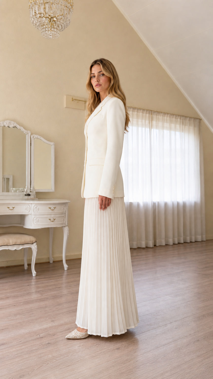 Side profile view of ivory tailored suit set with long pleated pants