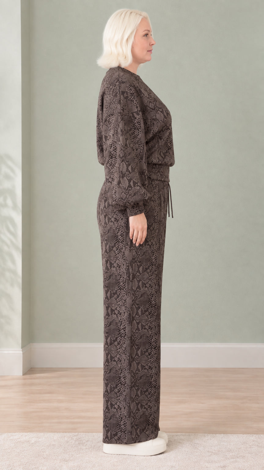 Side view of woman wearing dark brown snakeskin print two-piece loungewear set