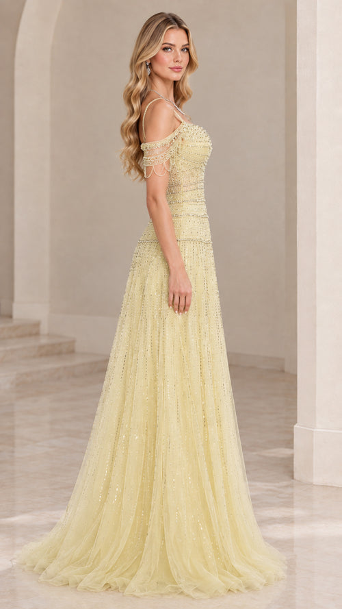 Side profile view of light yellow tulle formal gown showing silhouette