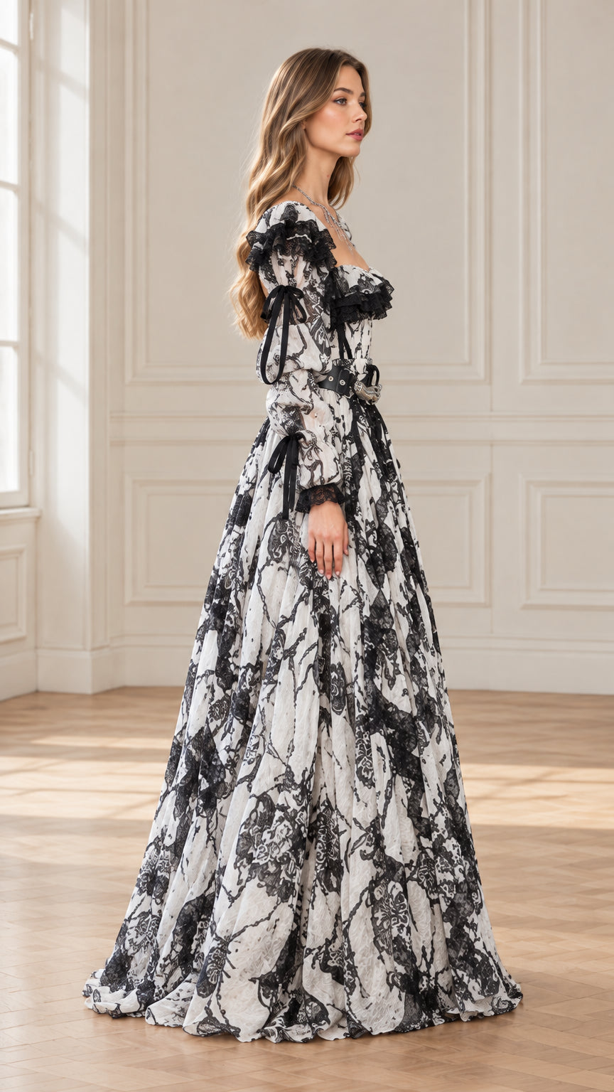 Side profile of woman in white and black vintage gothic ball gown showing floor-length flared skirt